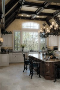Dark beams, high ceilings and a mixture of wood tones with white cabinetry complement this kitchen design